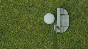 golf putter and ball on grass