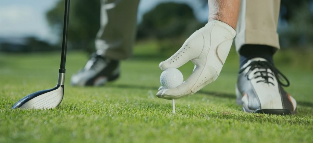 placing golf ball on tee closeup